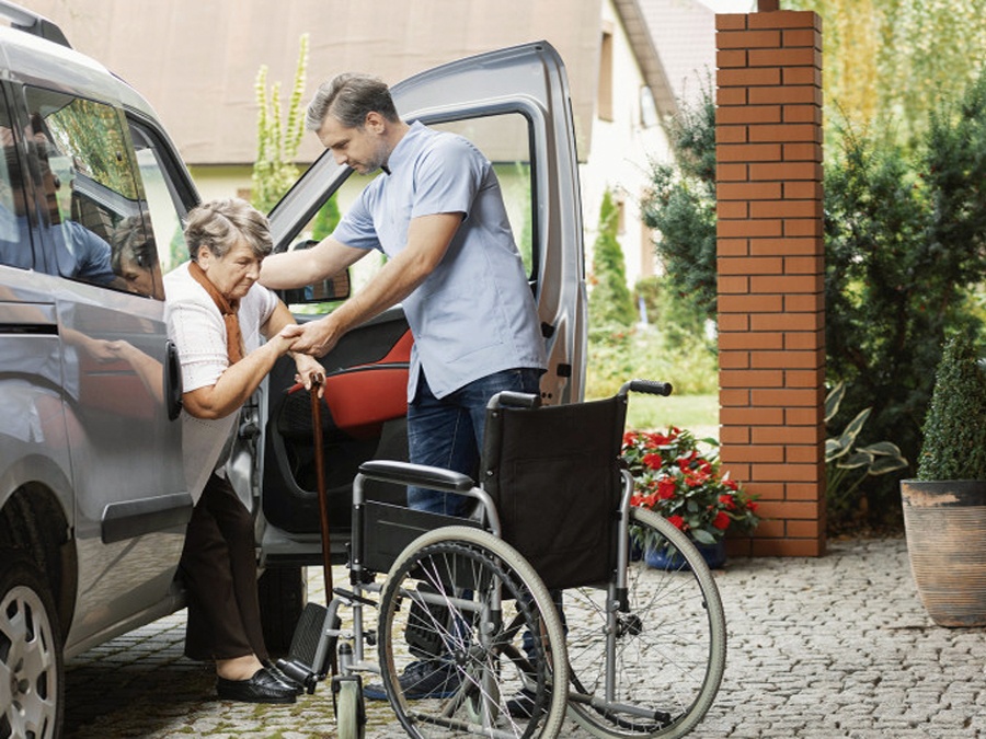 Man helping lady into car Man helping lady into car